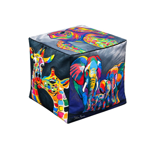 A cube-shaped pouf ottoman featuring a vibrant, colorful pop-art design with giraffes and elephants on a dark background, shown on a plain white studio background.