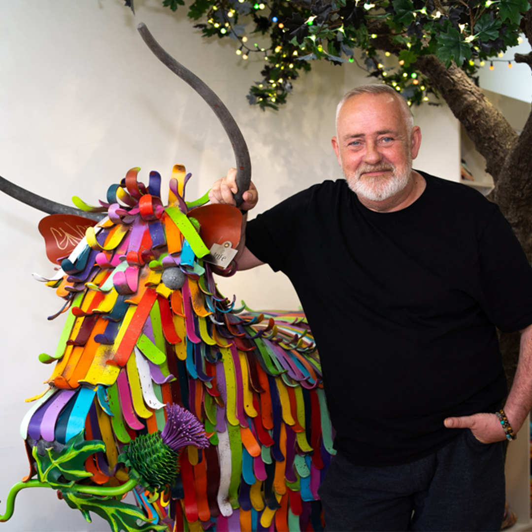 Steven Brown with a highland cow sculpture